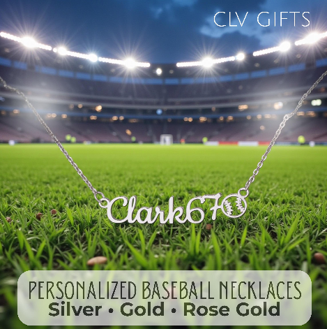 Silver-tone personalized baseball necklace on grass in a stadium under lights.