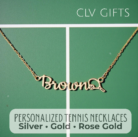 Gold-tone Brown name necklace with a tennis racket motif on a green tennis court.
